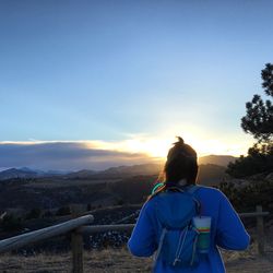 Rear view of woman looking at sunset