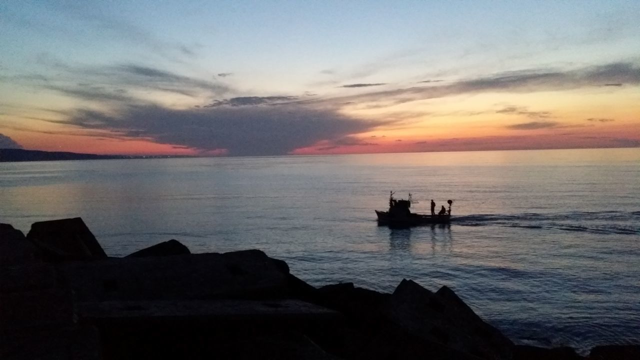 sea, sunset, water, silhouette, horizon over water, sky, scenics, beauty in nature, nautical vessel, tranquil scene, tranquility, transportation, mode of transport, boat, nature, cloud - sky, orange color, idyllic, dusk, outdoors