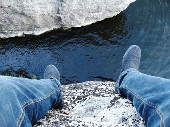 Low section of man standing on water