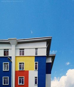 Low angle view of building against blue sky