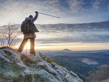 Man standing on mountain against sky
