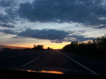 Road against sky seen through car windshield