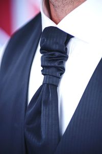 Close-up midsection of well-dressed bridegroom outdoors