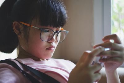 Close-up of girl using mobile phone