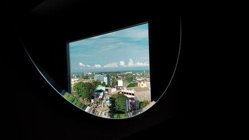 Buildings in city seen through window