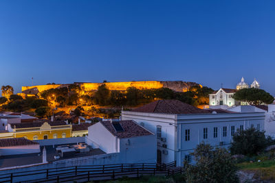 Houses and buildings against blue sky