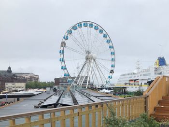 Ferris wheel in city against sky