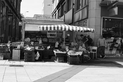 People at market stall in city