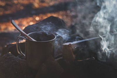 Close-up of container on campfire