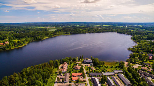 High angle view of houses and river against cloudy sky