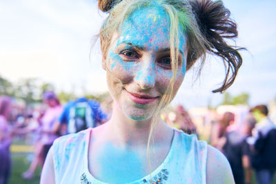 Close-up portrait of smiling beautiful woman at carnival