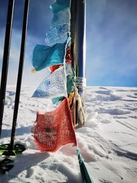 Clothes hanging on snow covered mountain against sky
