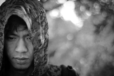 Close-up of thoughtful young man wearing hood