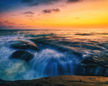 Scenic view of sea against cloudy sky