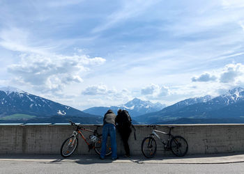 Bicycles on snowcapped mountains against sky