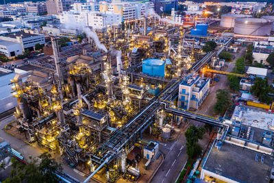 High angle view of factory in city at dusk