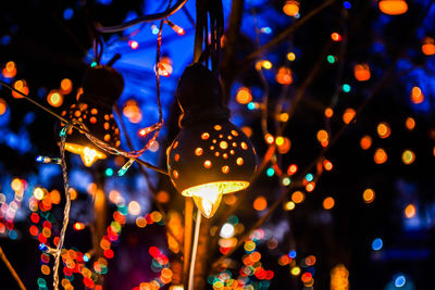 Close-up of illuminated lighting equipment hanging on christmas lights