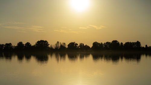 Scenic view of lake against sky during sunset