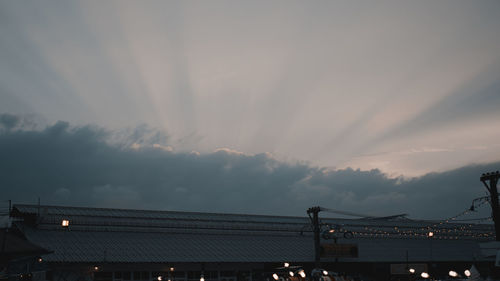 Low angle view of illuminated bridge against sky at sunset