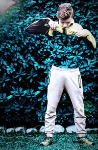 Midsection of woman standing by stone wall