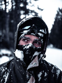 Portrait of woman with snow covered tree