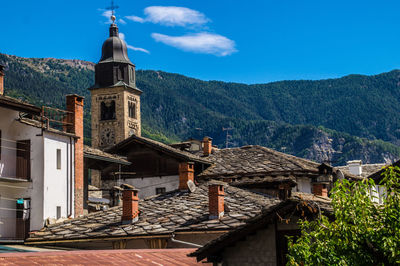 High angle view of houses and buildings against blue sky