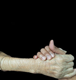 Close-up of hands over black background