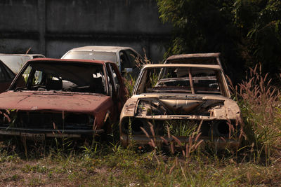 Abandoned car in field