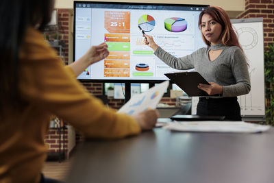 Portrait of businesswoman using laptop at office