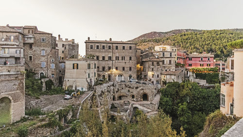 Buildings in town against clear sky