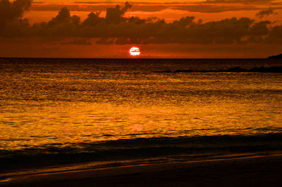 Scenic view of sea against romantic sky at sunset