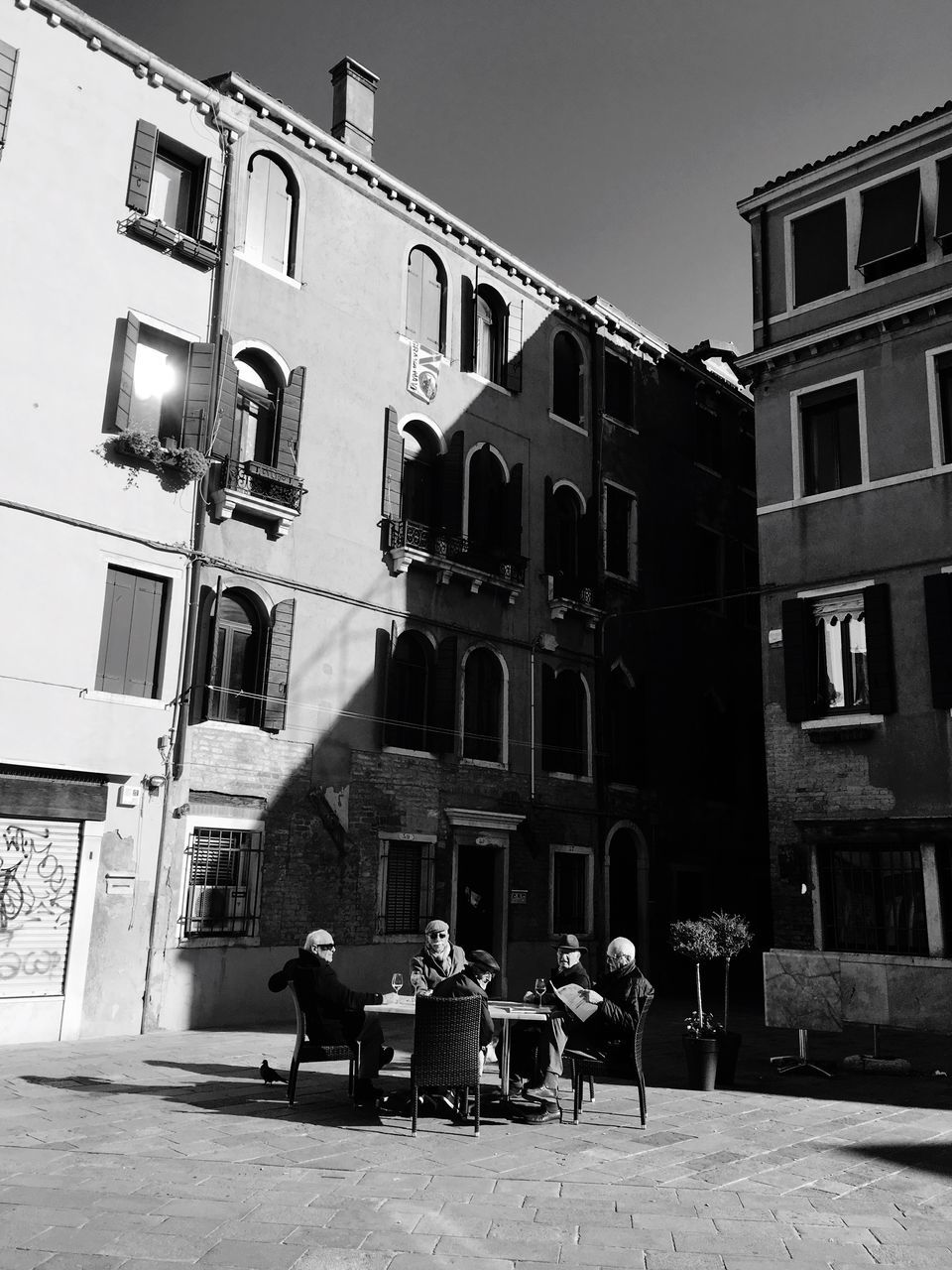 building exterior, architecture, built structure, chair, real people, outdoors, sitting, men, women, city, day, sky, people