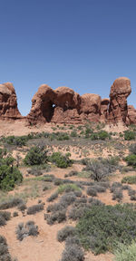 Rock formations in desert against clear sky