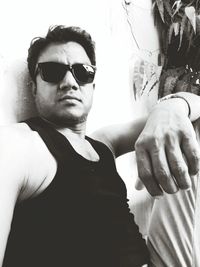 Portrait of young man wearing sunglasses standing outdoors