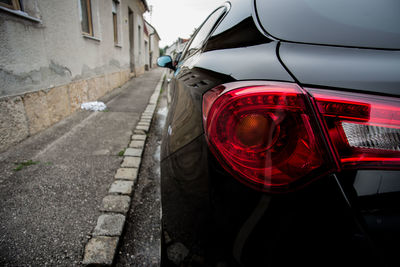 Close-up of red car on road