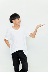 Young man standing against white background