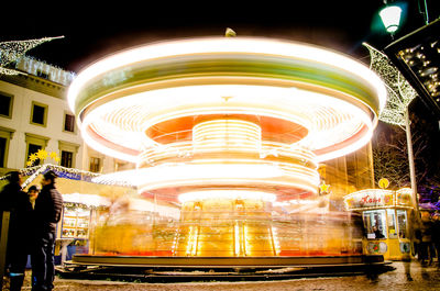 Spinning illuminated carousel on a nightly christmas market