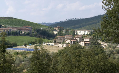 High angle view of townscape by mountain against sky