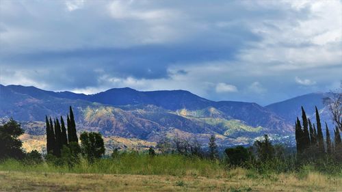 Scenic view of mountains against cloudy sky