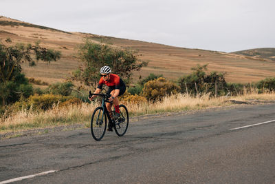 Man riding bicycle on road