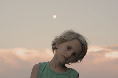 Portrait of boy against sky during sunset