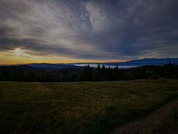 Scenic view of field against sky during sunset