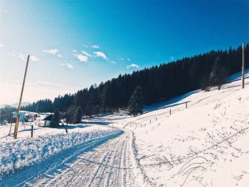 Scenic view of snow covered landscape against sky