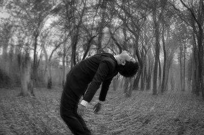 Full length of man on field in forest