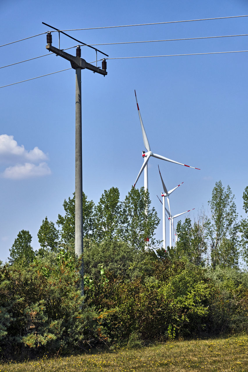 LOW ANGLE VIEW OF WIND TURBINES ON LAND