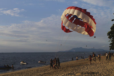 People on beach against sky