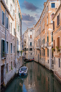 Traditional gondolas on the narrow canal in venice, italy.