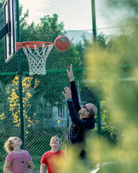 Man playing with basketball hoop