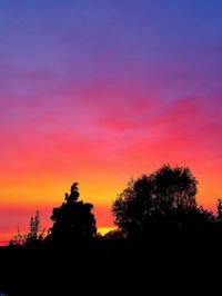 Silhouette trees against sky during sunset