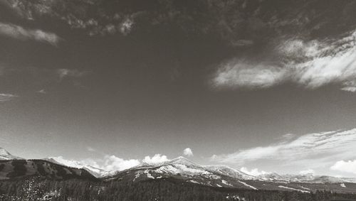 Scenic view of mountains against cloudy sky